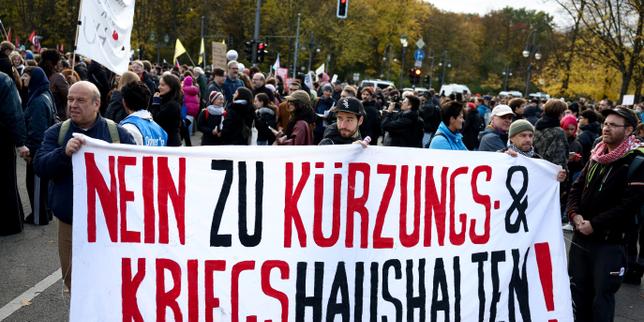 Demonstrators holding a banner reading No to austerity and war budgets in Berlin