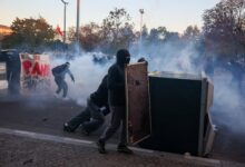Protesters holding makeshift shields during a demonstration in Paris.