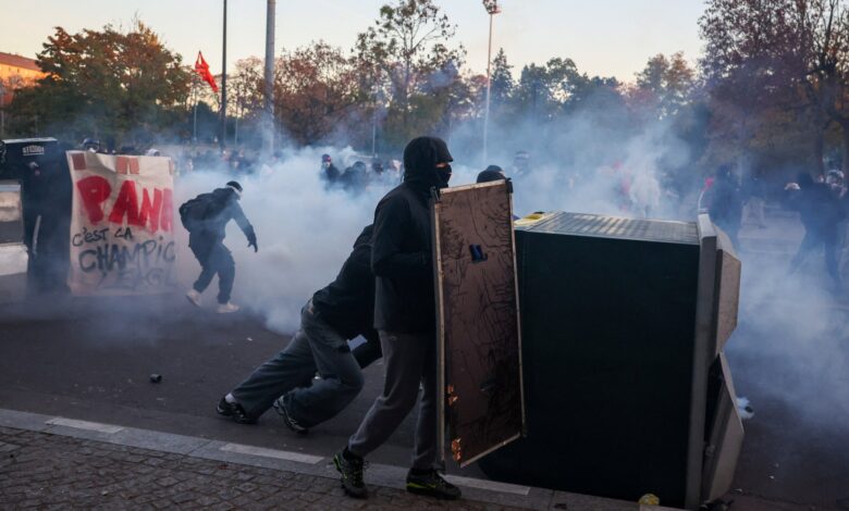 Protesters holding makeshift shields during a demonstration in Paris.