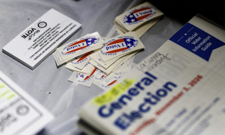 A 'I voted' sticker rests on a table next to a secure ballot box during early voting.